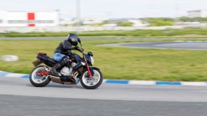 A motorcycle racer makes a practice run on a sports track